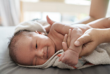new born infant taking a bath in the morning and changing clothes and diaper
