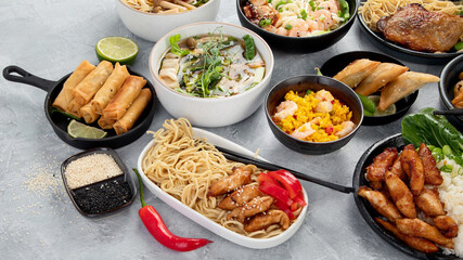 Assorted asian dishes and snacks on dark gray background. Traditional food concept.