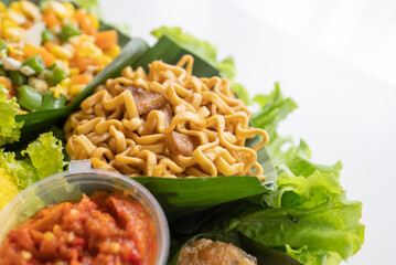 nasi tumpeng. indonesian cuisine yellow rice on banana leaf for celebration