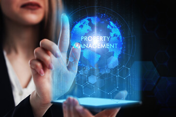 Business, Technology, Internet and network concept. Young businessman working on a virtual screen of the future and sees the inscription: Property management