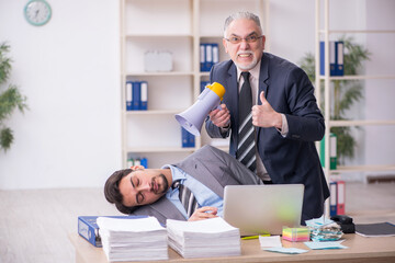 Two male employees in bullying concept