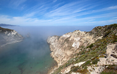 Potato Harbor on Santa Cruz Island with mist coming in under blue cirrus sky in the Channel Islands National Park offshore from Santa Barbara California USA