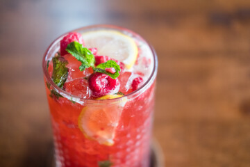 Cold drink black tea of raspberry lemonade with mint in glass