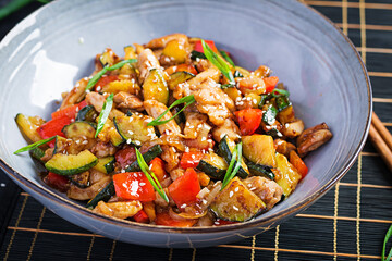 Stir fry with chicken, zucchini and sweet peppers - Chinese food.