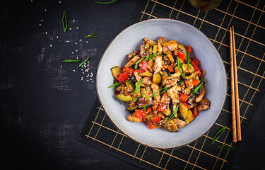Stir fry with chicken, zucchini and sweet peppers - Chinese food. Top view, above