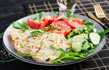 Trendy salad. Chicken meatloaf with salad fresh tomatoes and cucumber. Healthy food, ketogenic diet, diet lunch concept. Keto, Paleo diet menu.