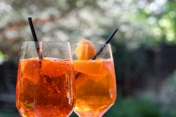 Summer cocktails with orange, lime and mint. Alcoholic cocktail in a tall glass on a stem. Gin tonic long drink. 