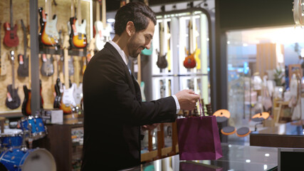An upwardly mobile Muslim man using smart payment to pay for a product at a sale terminal with nfc identification payment for verification and authentication
