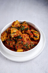 Ayam Rica-Rica. Traditional dish from Manado, Indonesia, braised chicken in spicy paste and garnish with lemon basil.