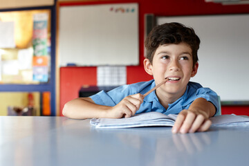 Primary school student in classroom doing homework