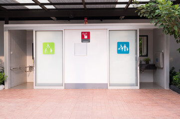 Outdoor public toilet and different signs.The pregnant symbol and disable symbol on toilet doors.