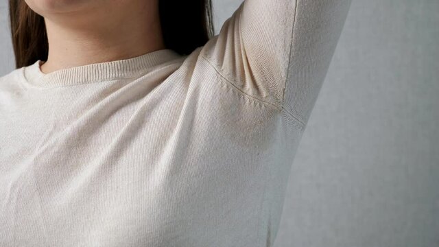 Wet armpit of an unrecognizable woman. Stress concept, hormonal disruption.