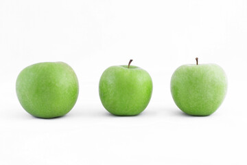 Three ripe healthy green apples on a white background