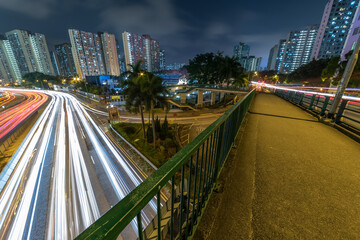 Fototapeta na wymiar Light trail of traffic on highway and pedestrian walkway in Hong Kong city at night
