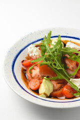 Tomato and salmon salad with cheese and spices. Traditional Italian cuisine, Italian concept.