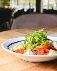 Tomato and salmon salad with cheese and spices. Traditional Italian cuisine, Italian concept.