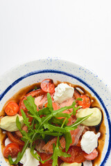 Tomato and salmon salad with cheese and spices. Traditional Italian cuisine, Italian concept.