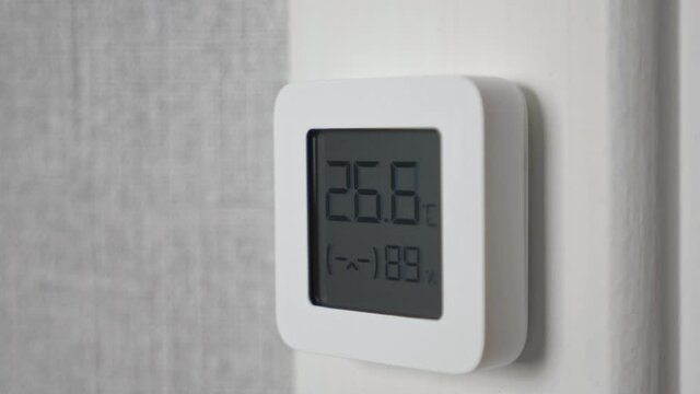 Indoor electronic thermometer shows temperature and humidity.