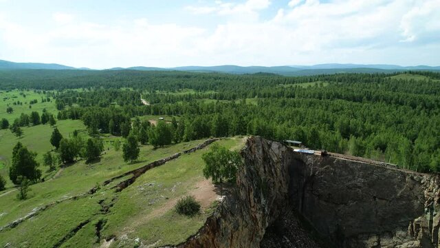 a sinkhole in the mountain, a flooded mine. Mountain lake in khakassi, an unusual krsivy view. Forest and sky