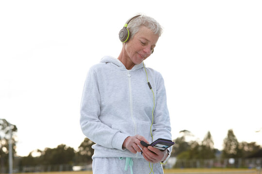 Active senior listening to music with headphones