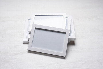 A stack of empty picture frames with copy space on the white flat lay background.