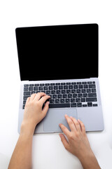 Fototapeta na wymiar Girl's hands on laptop keys, top view