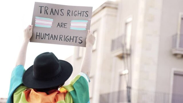 Transgender people at gay pride holding trans human rights flag banner - Lgbt celebration event concept