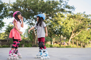 smiling 5 year old asian girl going on her in-line skates