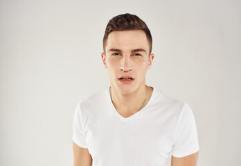 man with surprised facial expression in white t-shirt emotions cropped view