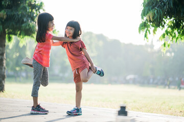 Fototapeta premium two Asian girl is stretching exercise in the park in the morning