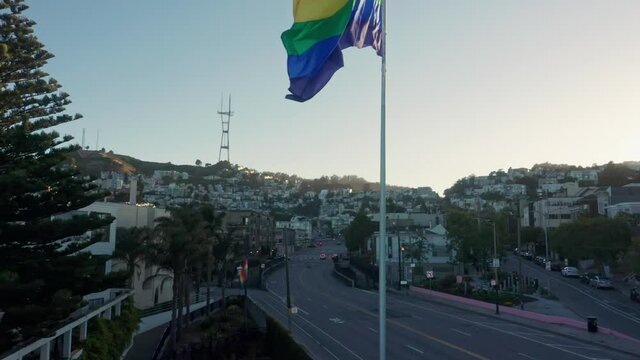 Aerial: Giant rainbow flag flapping in the wind in the Castro district, San Francisco, USA