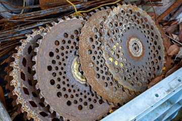 Images of several rusty chip saws.