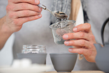 Fototapeta na wymiar woman hands preparing hot tea