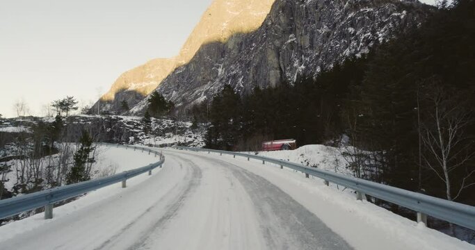 Slippery Road Covered In Snow By The Mountainside In Eresfjord In Norway - moving shot