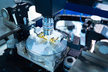 Chip testing equipment. Manufacturing of microchips. A close-up study of a test sample of a transistor chip under a microscope in the laboratory. Automation of production.
