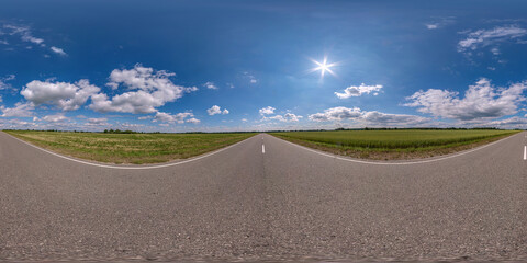 full seamless spherical hdri panorama 360 degrees angle view on no traffic asphalt road among field in sunny day and blue sky with clouds in equirectangular projection, ready for VR AR virtual reality