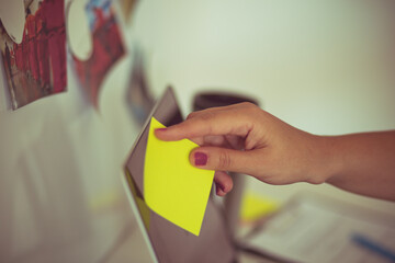 FBI woman works on a case in the office. Focus is on hand. Holding paper.