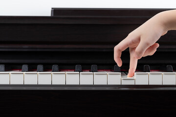 asian kid fingers walk on piano. concept : learning piano ,education.