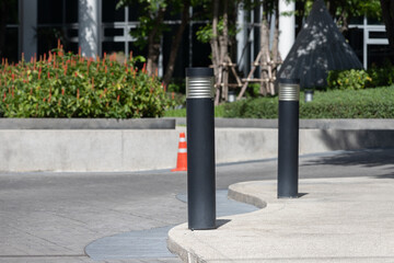 black light steel bollards on footpath.