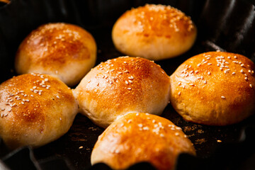 Fresh homemade bread taken from the wood oven. Close up of rustic whole meal bread rolls