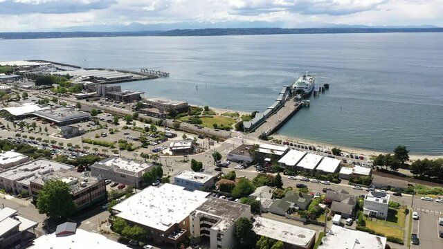 Cinematic 4K drone footage of the downtown Edmonds commercial area, Kingston ferry terminal, waterfront marina, Sunset beach near Seattle in Western Washington, Pacific Northwest, in Snohomish County