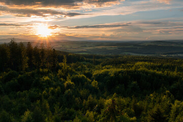 Summer forest Czech valley landscape with small vilage Besednice at sunset cloudy sky