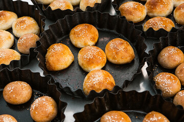 Fresh homemade bread taken from the wood oven. Close up of rustic whole meal bread rolls