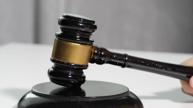  Equipment lawyer gavel being struck to decide an auction or guilty verdict in court