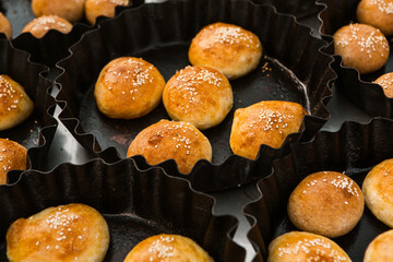 Fresh homemade bread taken from the wood oven. Close up of rustic whole meal bread rolls