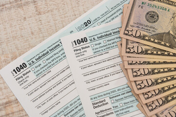 dollar bills on US individual 1040 tax form