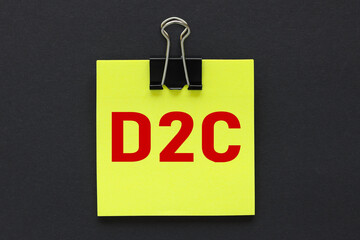 D2C. text on a black background, on a bright yellow sticker