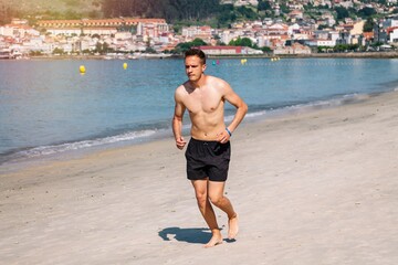 man running on the beach sand