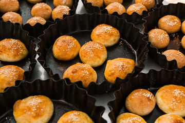 Fresh homemade bread taken from the wood oven. Close up of rustic whole meal bread rolls