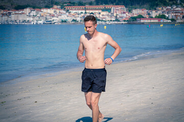 man running on the beach sand